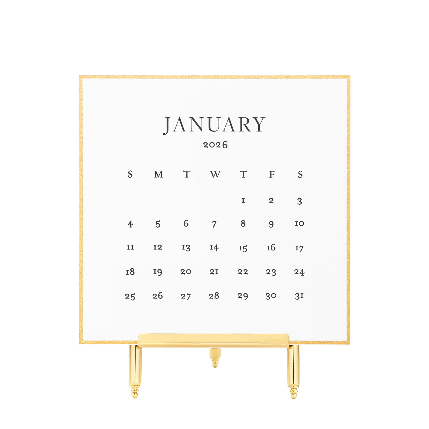 White calendar card with black letterpress ink for January 2026 on a brass stand