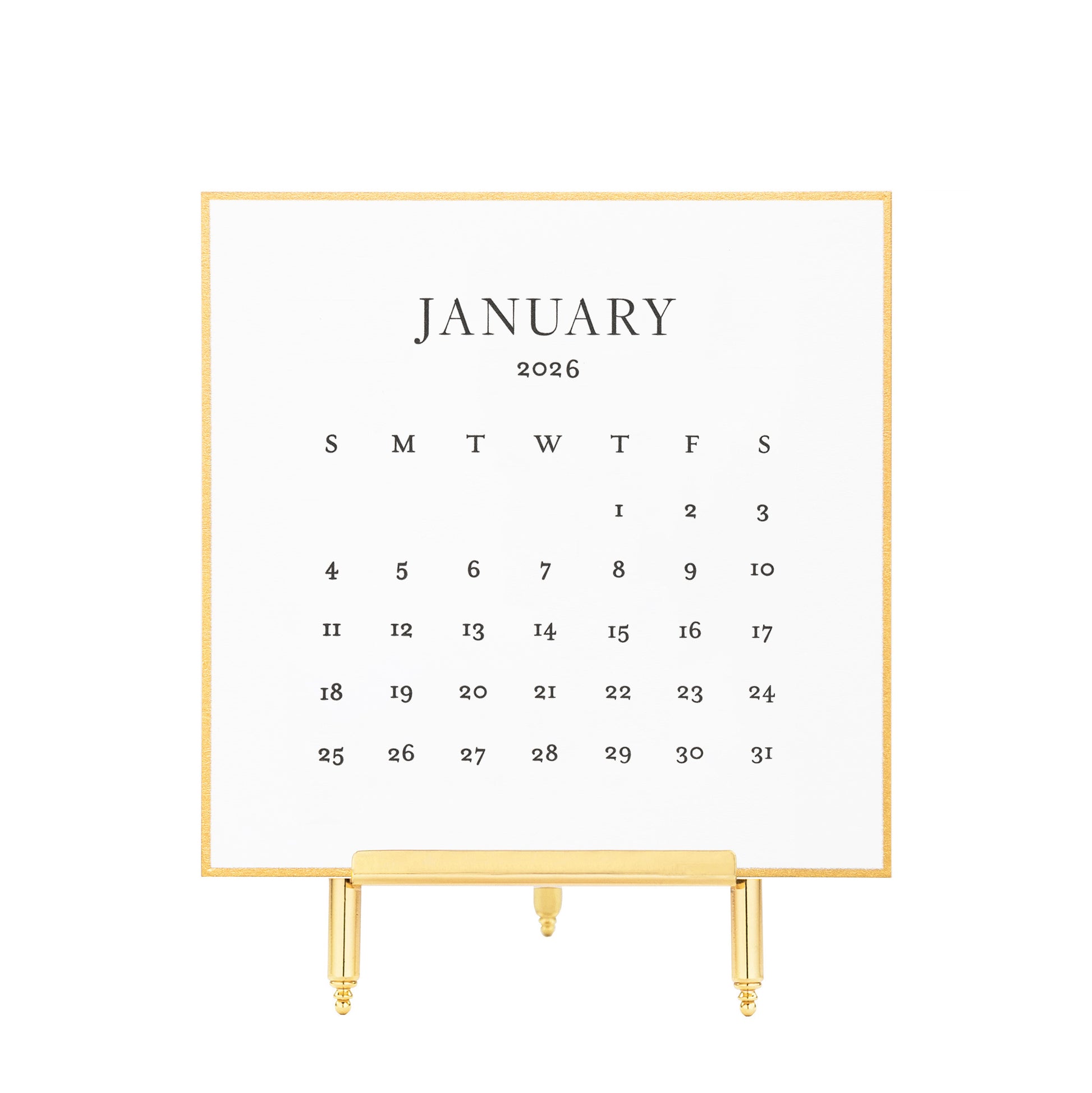 White calendar card with black letterpress ink for January 2026 on a brass stand