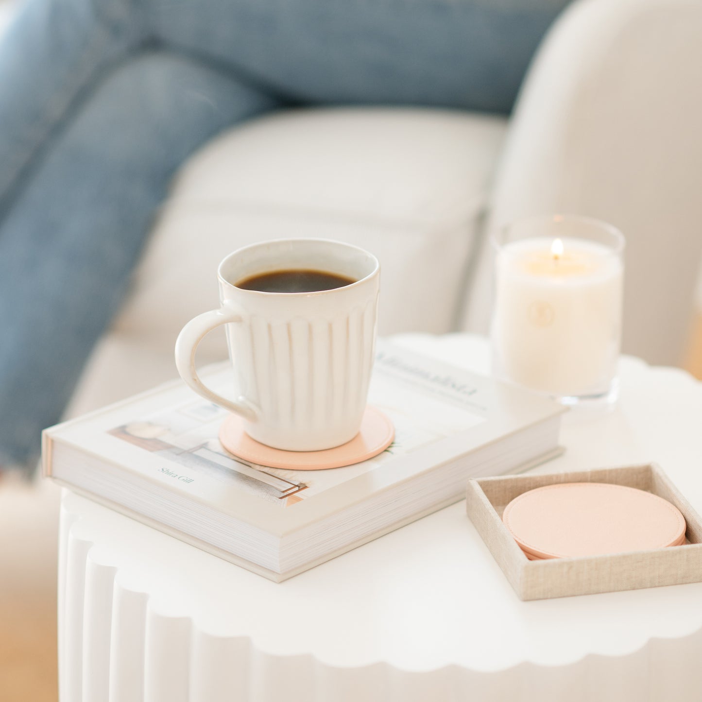 Pink coaster on side table with coffee