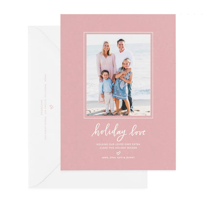 Rose and white holiday photo card printed with holiday love paired with a white envelope