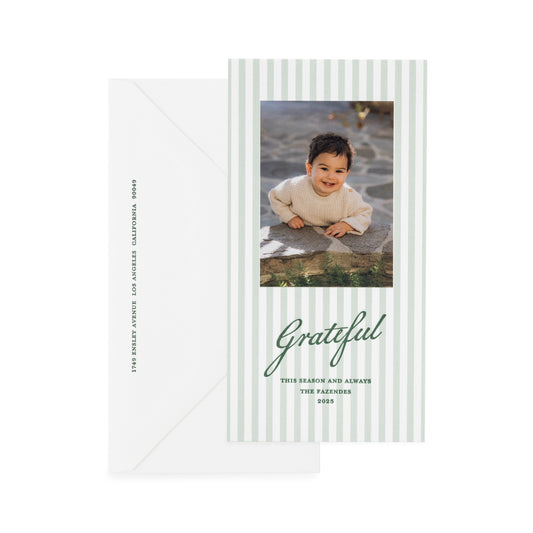 Custom holiday photo card with green stripes and green letterpress ink with 'grateful this season and always' greeting paired with a white envelope with green ink
