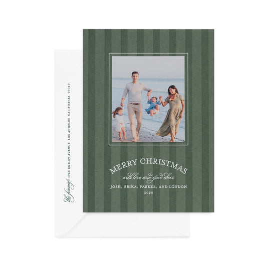 Rosemary green custom holiday card with dark green stripes with a photo of a family with white foil 'merry christmas with love and good cheer' paired a white envelope with dark green return address