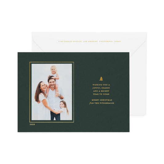 Dark forest green custom holiday photo card with gold foil message 'wishing you a joyful season and a bright year to come merry christmas' paired with a white envelope