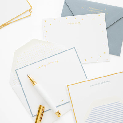 Custom stationery and a pen on a white surface.