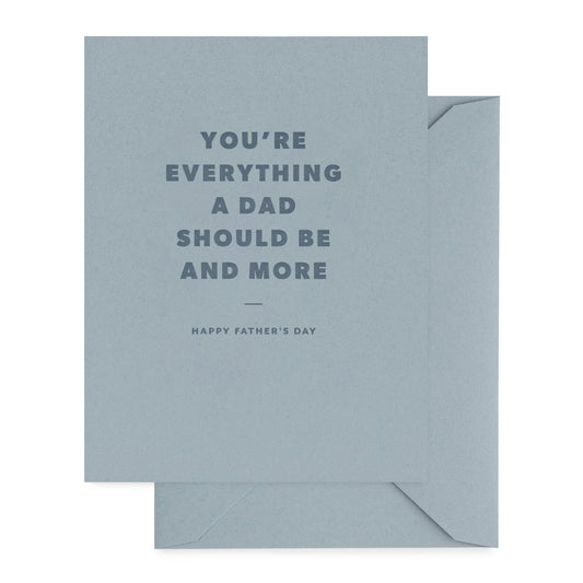 Father's Day card with 'you're everything a dad should be and more' with dark blue ink on a slate blue card with slate blue envelope