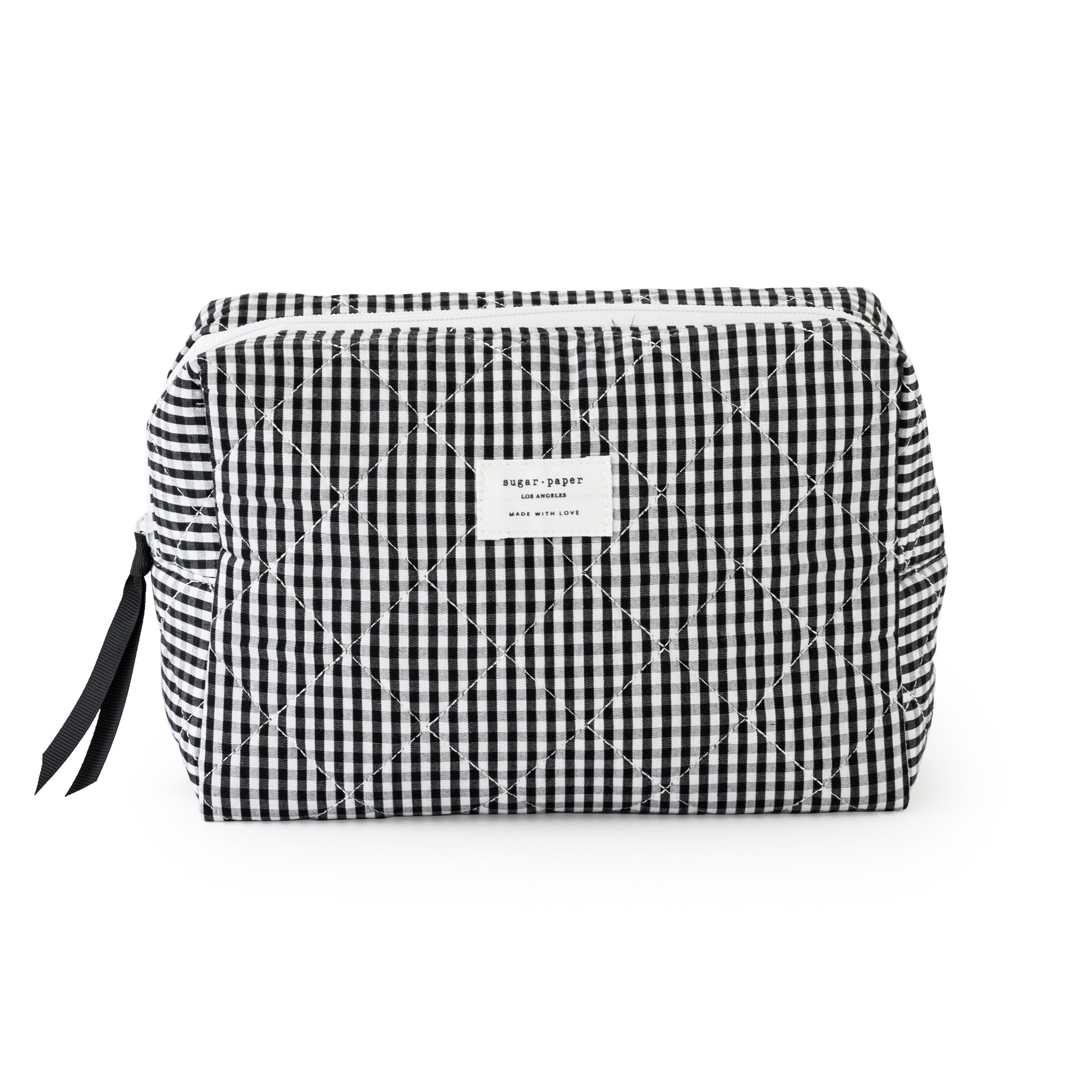 Large black and white checkered pouch with a sugar paper logo, with a black ribbon and white zipper
