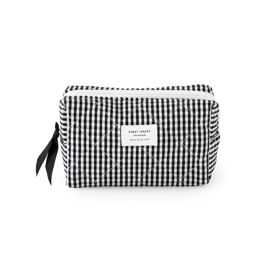 Black and white checkered pouch with a sugar paper logo, with a black ribbon and white zipper