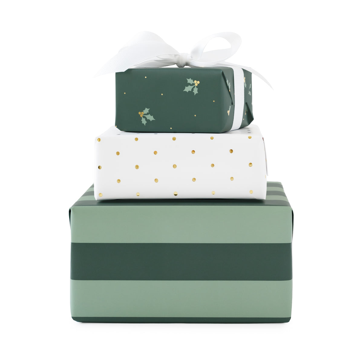 a stack of three wrapped gifts - one with thick mint and evergreen stripe wrap, one with white with gold foil swiss dots, and one that is evergreen with mint and gold foil holly berry and leaves tied with a white bow on top