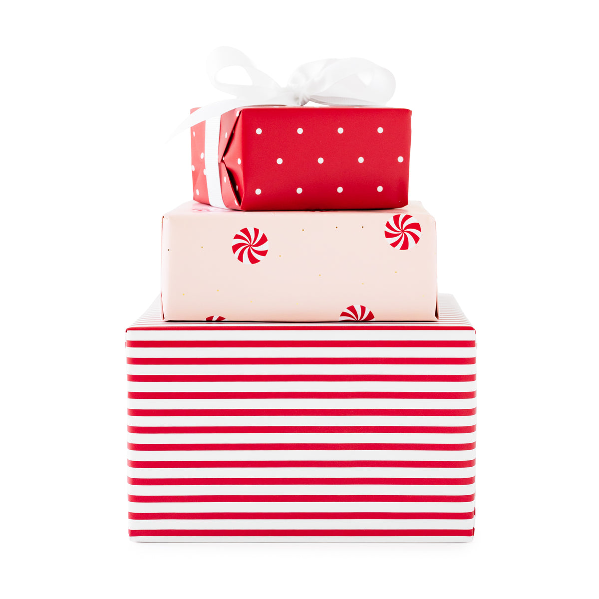 Three stacked Christmas-themed gift boxes wrapped in red and white paper, with a white ribbon bow on top