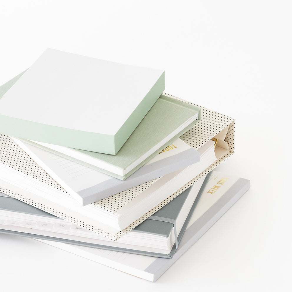 Stack of books with different cover materials on a white background