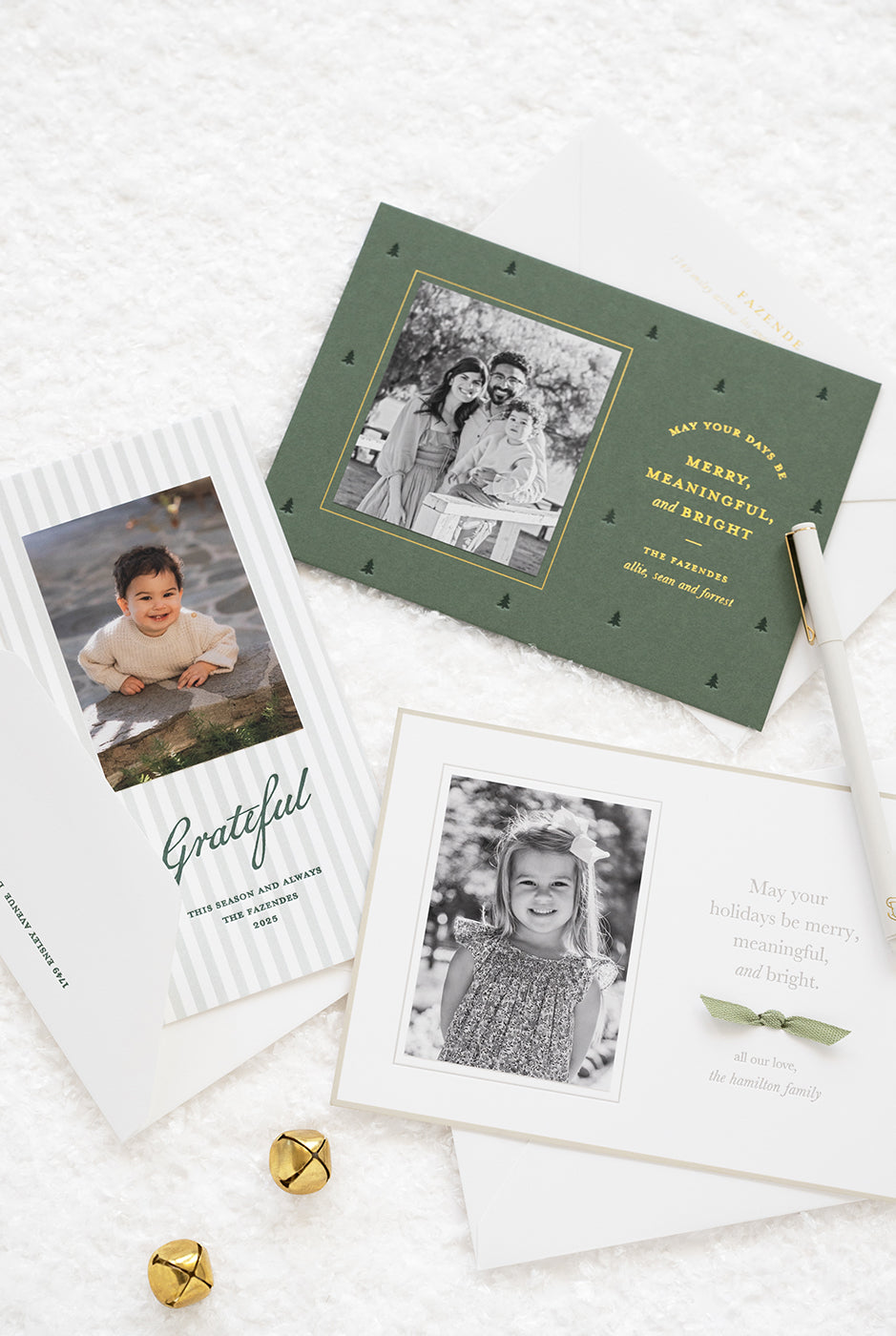 Set of holiday cards with photos and text on a white surface