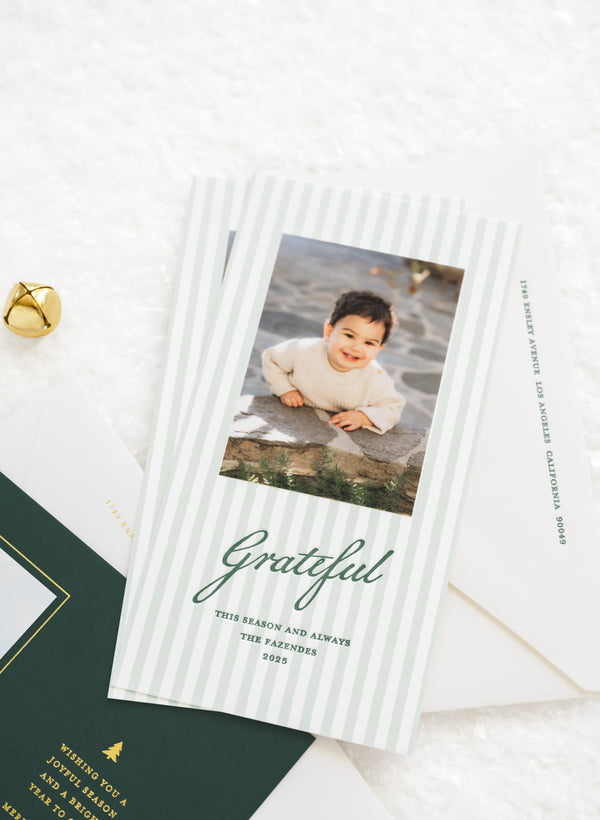 Green striped holiday photo card with photo of a little boy that is printed with green letterpress ink 'Grateful this season and always' the fazendes 2025