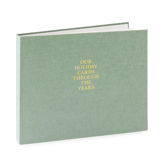 Green fabric bound album with gold foil 'our holiday cards through the years'
