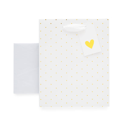 White gift bag wtih gold foil dot pattern, gold foil heart gift tag and sheets of white tissue paper