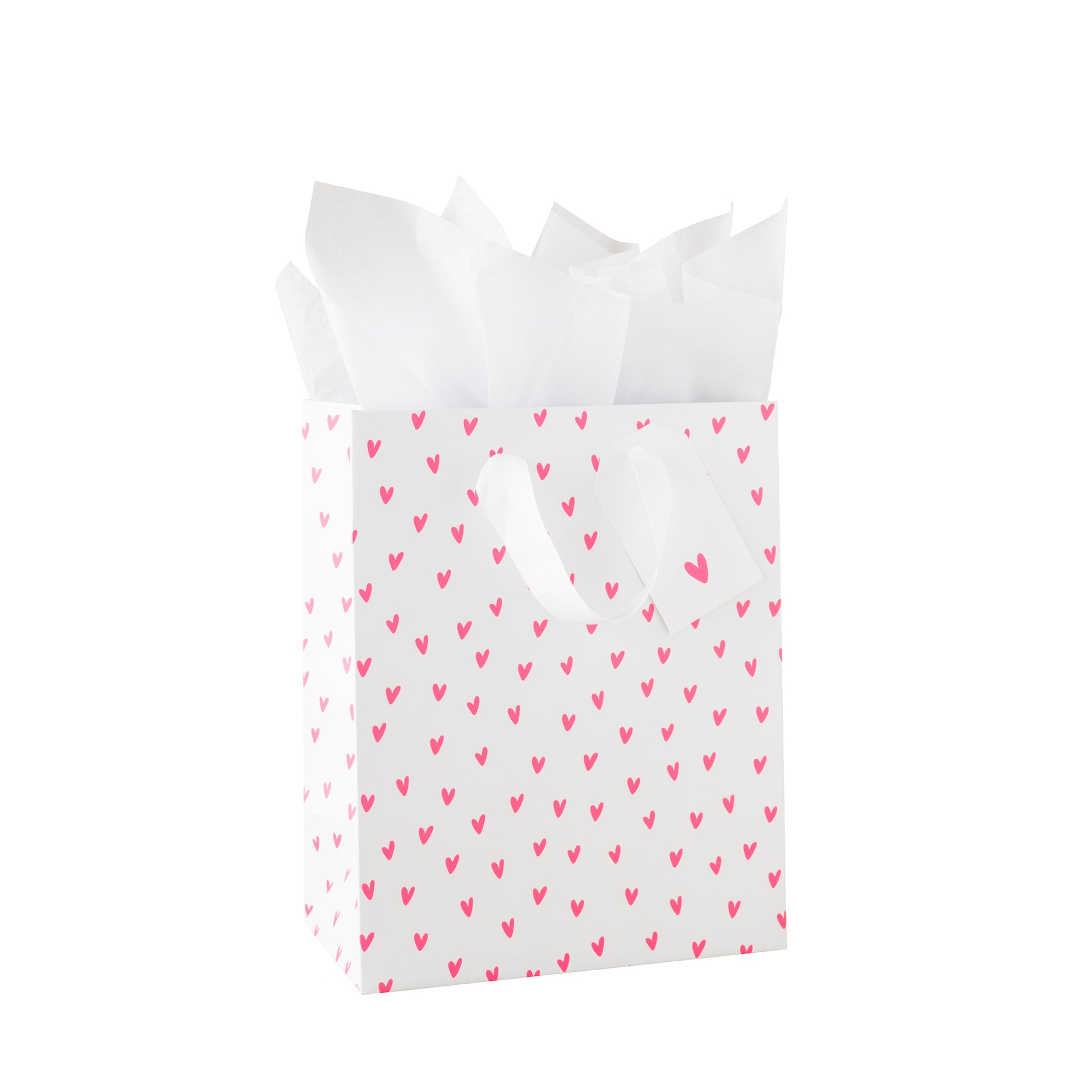 White gift bag with neon pink heart pattern, white tissue paper and a white gift tag with a neon heart pattern