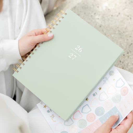 Office Green Spiral Planner with 26 27 on the cover