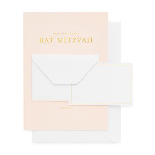 Pale pink greeting card with white small envelope and mini card printed with 'mazel tov on your bat mitzvah' in gold foil paired with a white envelope
