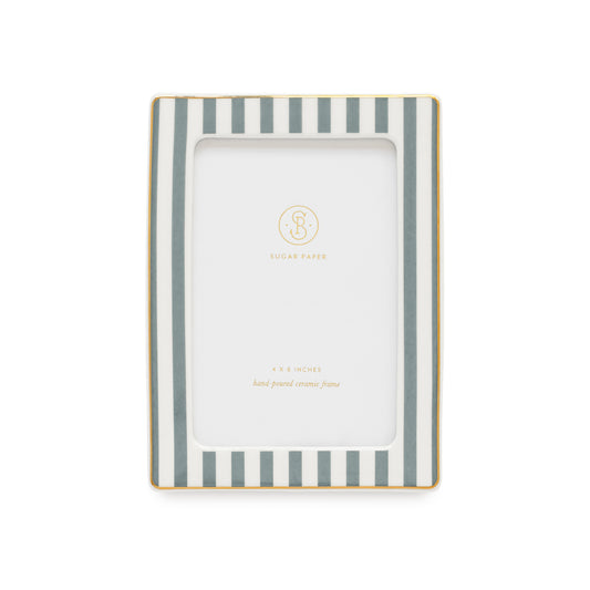 A rectangular picture frame with vertical dusty blue gray and white stripes and a thin gold border, shown on a plain white background. The center insert is blank with a small gold 'Sugar Paper' logo and '4x6 inches hand-poured ceramic frame'