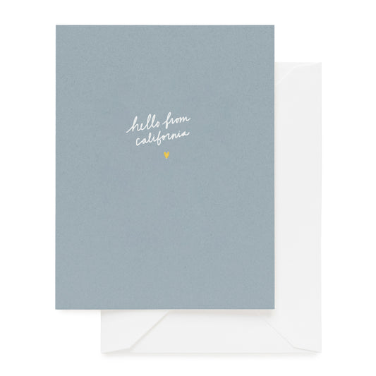 Slate blue card foil printed with hello from california and gold heart