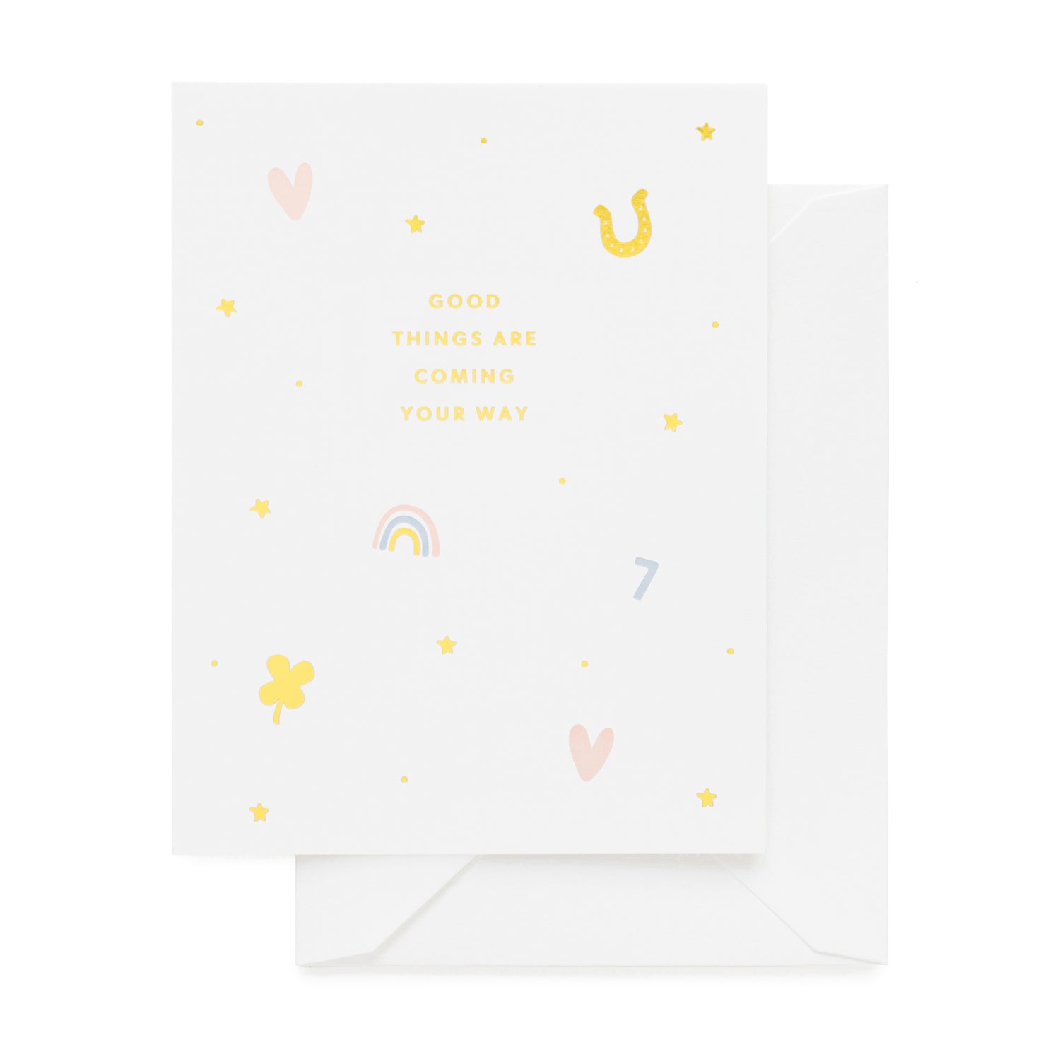 White greeting card with gold foil, pink, and blue icons in heart, horseshoe, rainbow, and lucky charm printed with 'good things are coming your way'}