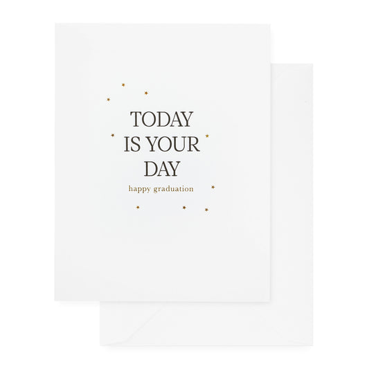 white card with black and gold text, white envelope