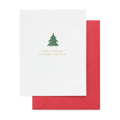 white christmas card with green tree and gold text, red envelope