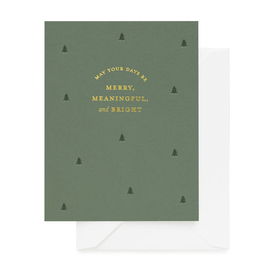 Green greeting card with gold foil 'may your days be merry meaningful and bright' and small tree pattern with a white envelope