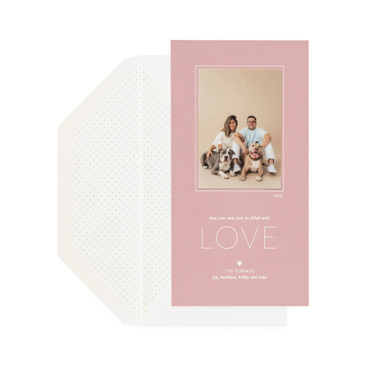 rose pink custom holiday photo card foil printed with may your new year be filled with love and paired with a white envelope with pindot envelope liner