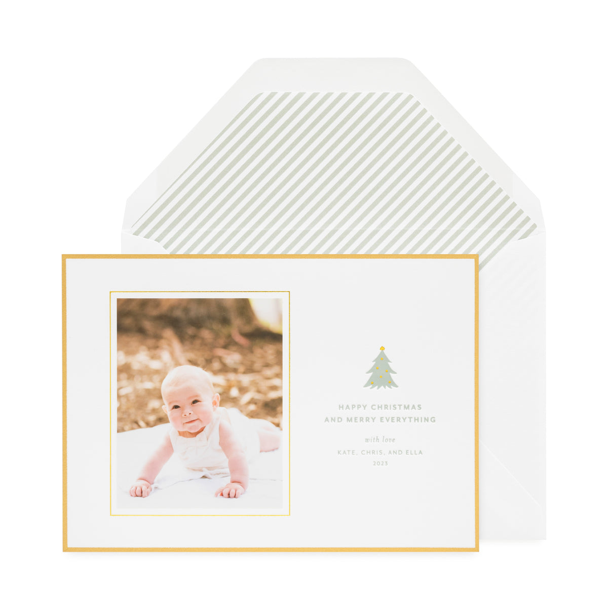 Gold bordered Christmas holiday card with green tree icon and green stripe envelope liner