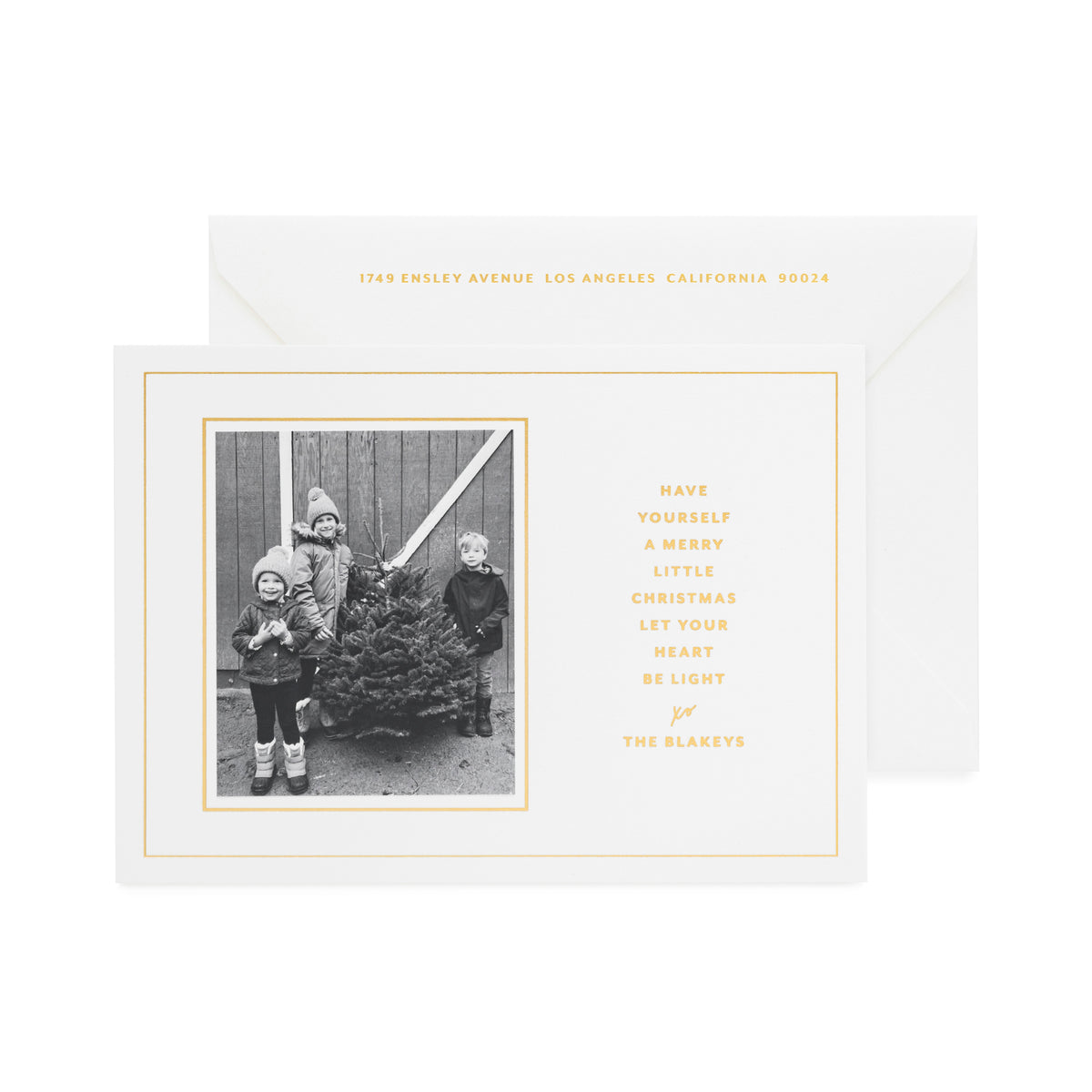 White and gold foil custom holiday card with black and white photo of three kids
