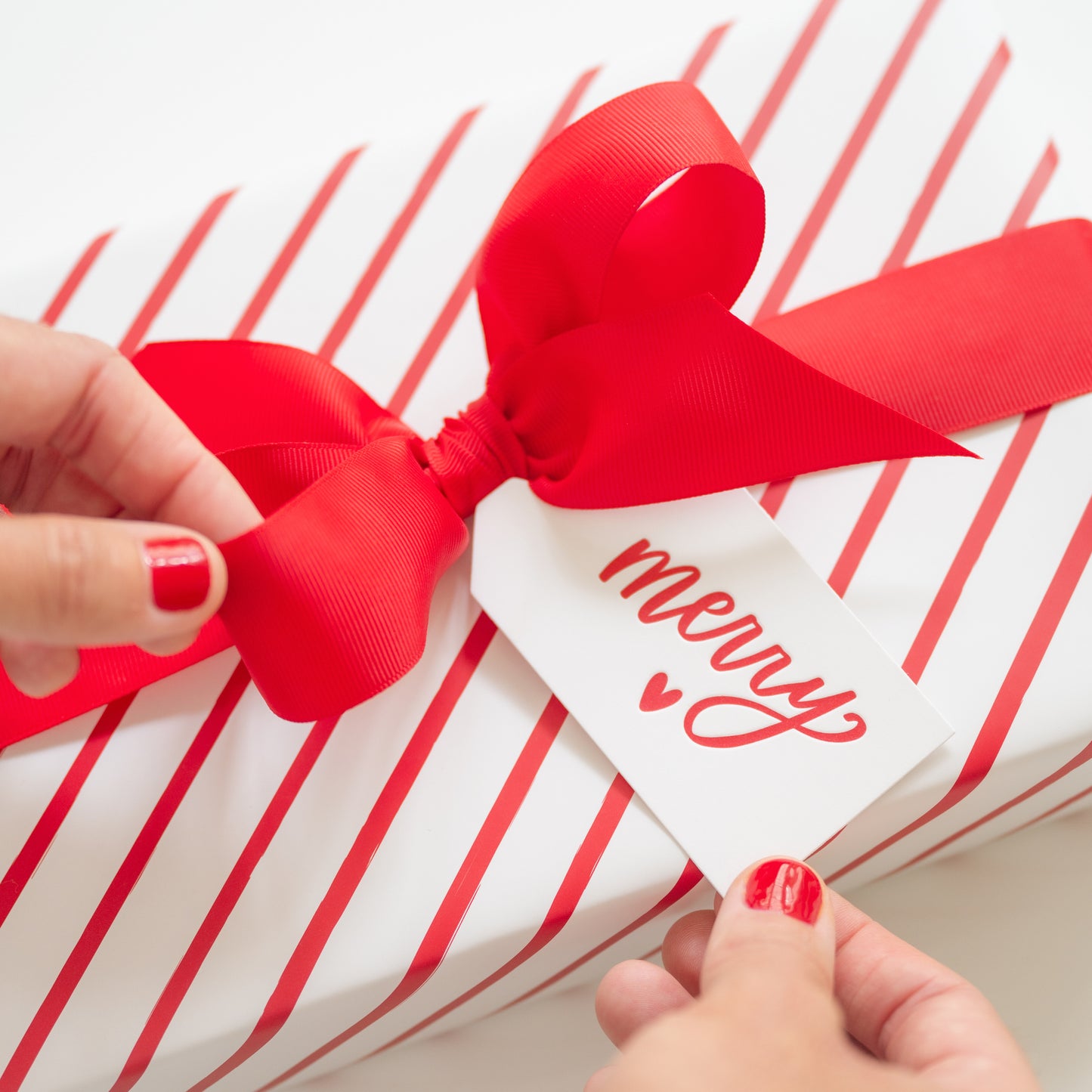 red and white diagonal stripe gift with ribbon and tag