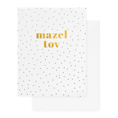 white card with gold mazel tov text and black dots, white envelope