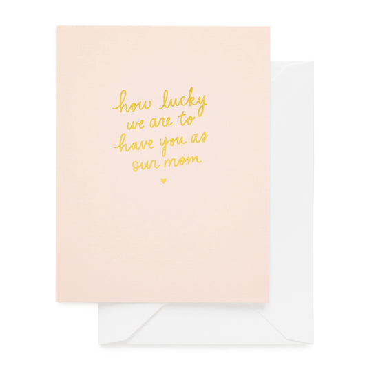 pink card printed with how lucky we are to have you as our mom in gold foil paired with a white envelope