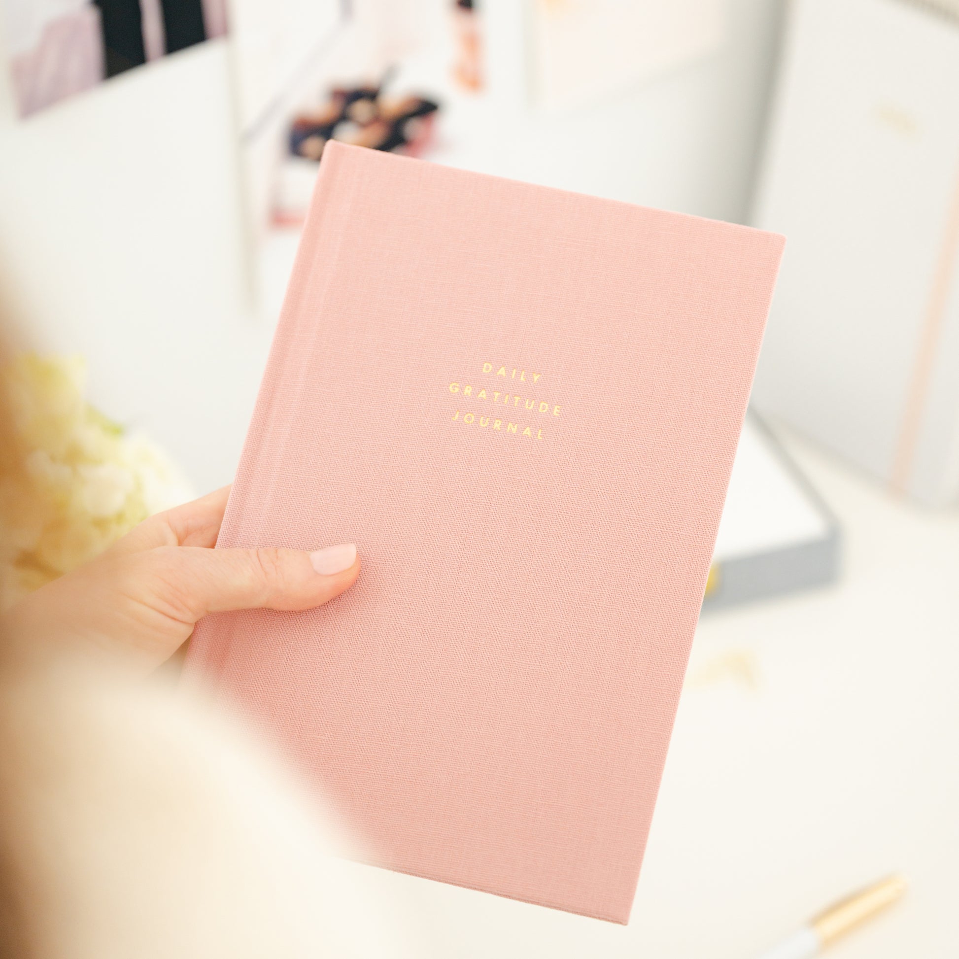 Cover of rose gratitude journal in hand