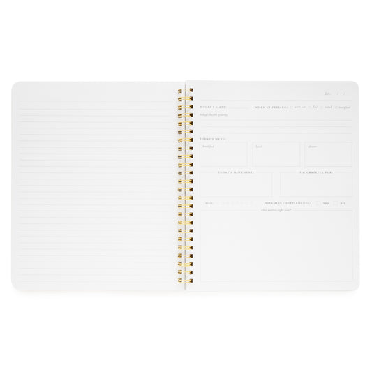 Interior of wellness notebook with daily prompts, menu, water tracker, supplements, today's movement, and grateful for