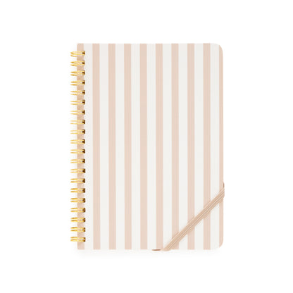 Notebook with blush and white striped cover and gold spiral binding