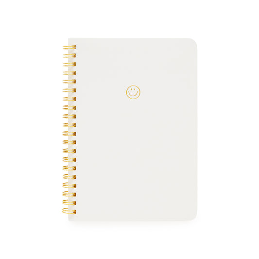 white mini spiral notebook with gold foil smiley face and gold spiral binding