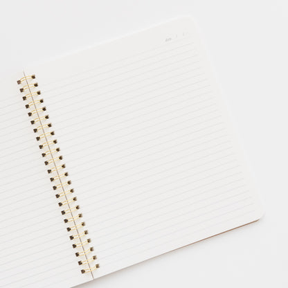 closeup of interior of spiral notebook with lined pages and date