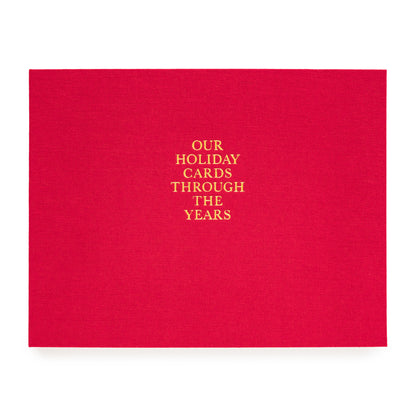 Red holiday card book printed with our holiday cards through the years