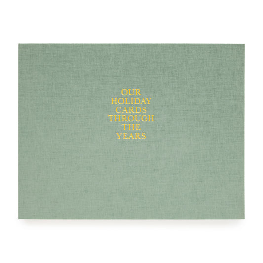 Sage green holiday card book foil stamped with our holiday cards through the years in gold foil on cover