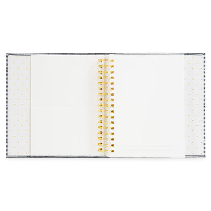 Interior of the halloween book featuring white pages with a gold wire coil binding and gold polka dots on the interior binding featuring pockets for keespakes