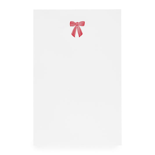 White notepad with red ribbon bow