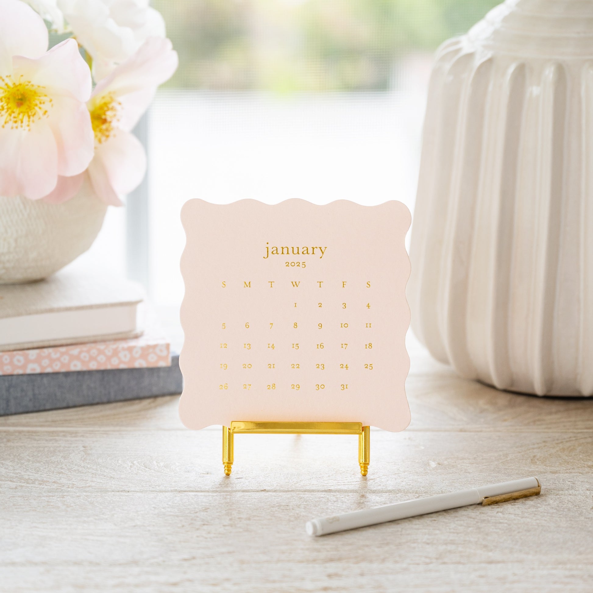 Pink desk calendar on desk