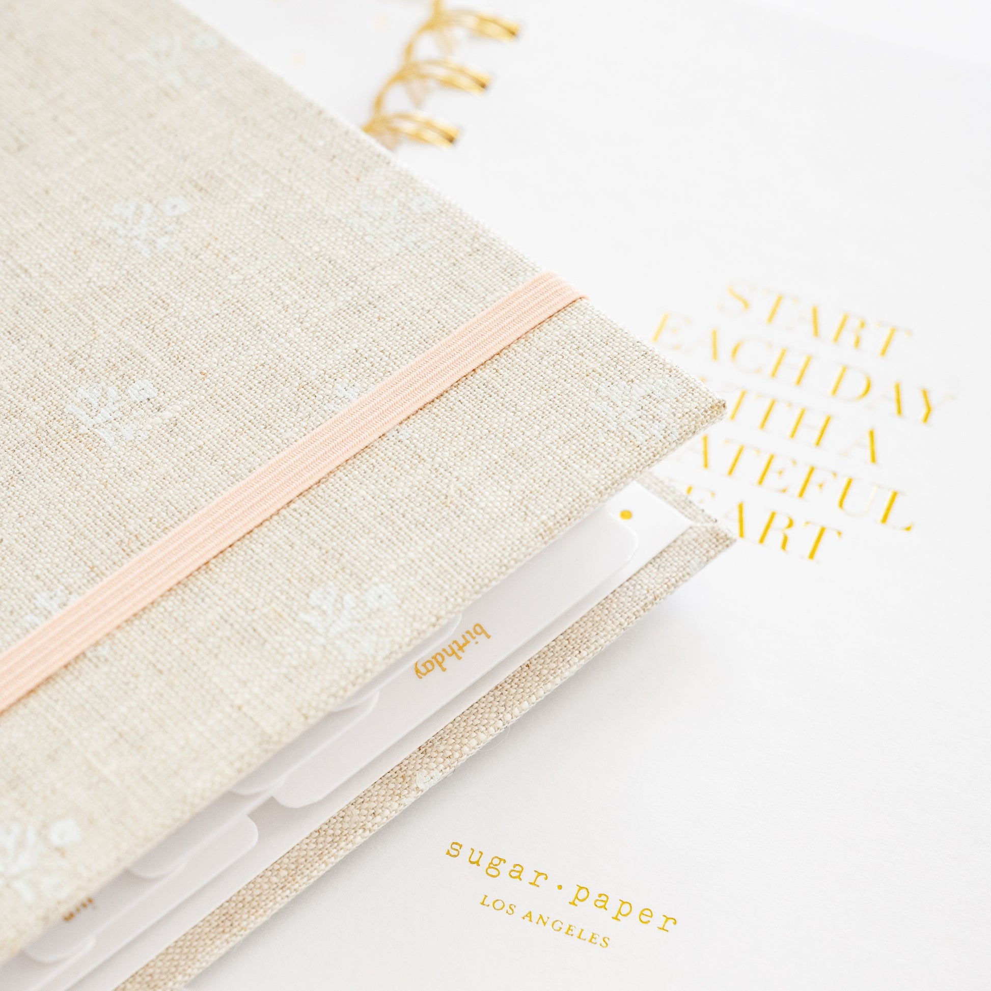 Detail of 2026 concealed planner showing birthday tab and interior quote 'start each day with a grateful heart'
