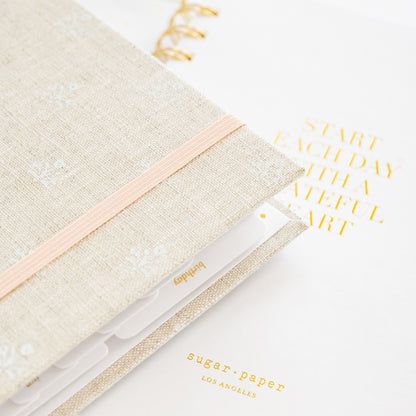 Detail of 2026 concealed planner showing birthday tab and interior quote 'start each day with a grateful heart'
