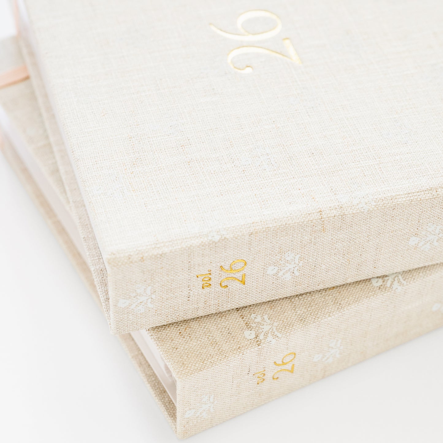 Stack of two fabric bound planners showing vol 26 on spine