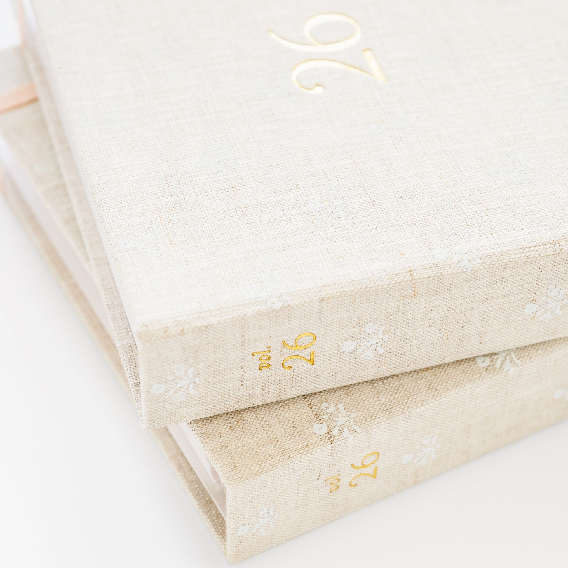 Stack of two fabric bound planners showing vol 26 on spine