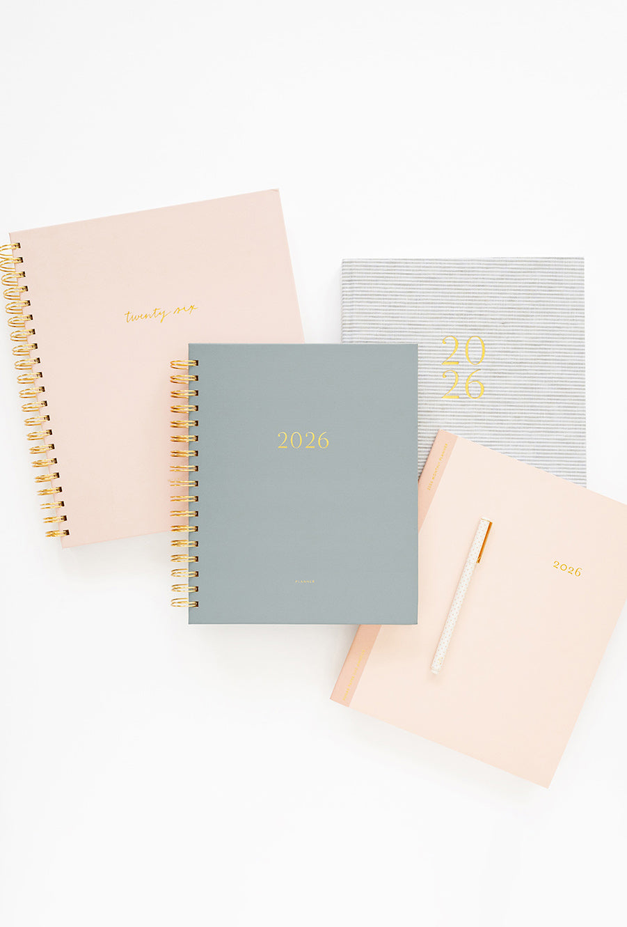 Set of three planners in beige, gray, and pink on a white background