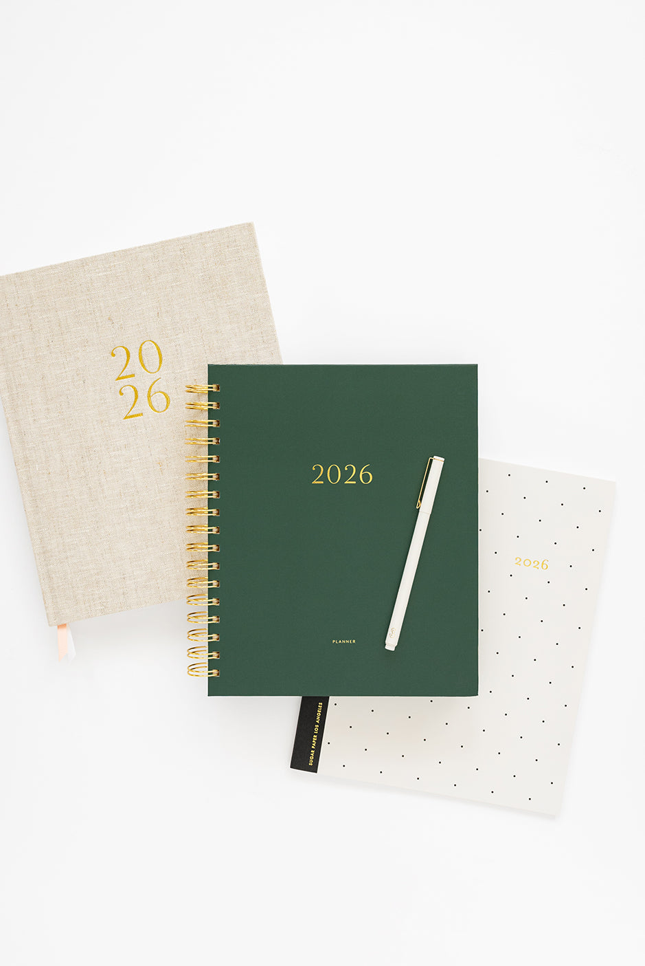 Set of three planners with different cover designs on a white background