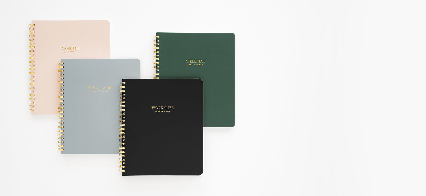 Four notebooks in different colors on a white background
